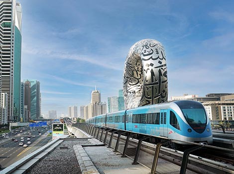 an image of Dubai Metro beside Museum of The Future