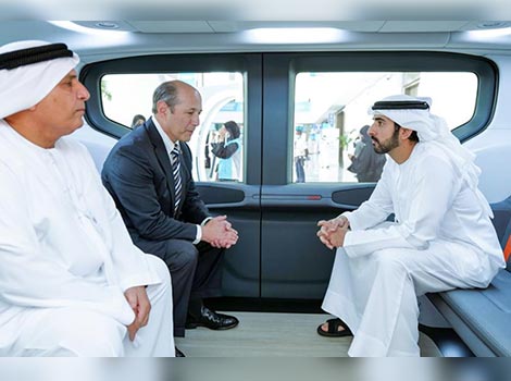 an image of His Highness Sheikh Hamdan bin Mohammed bin Rashid Al Maktoum, visiting the display of a model of the Origin autonomous vehicle manufactured by Cruise Inc.