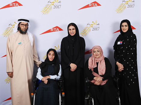 an image  People of Determination while receiving the wheelchair from RTA's employees 